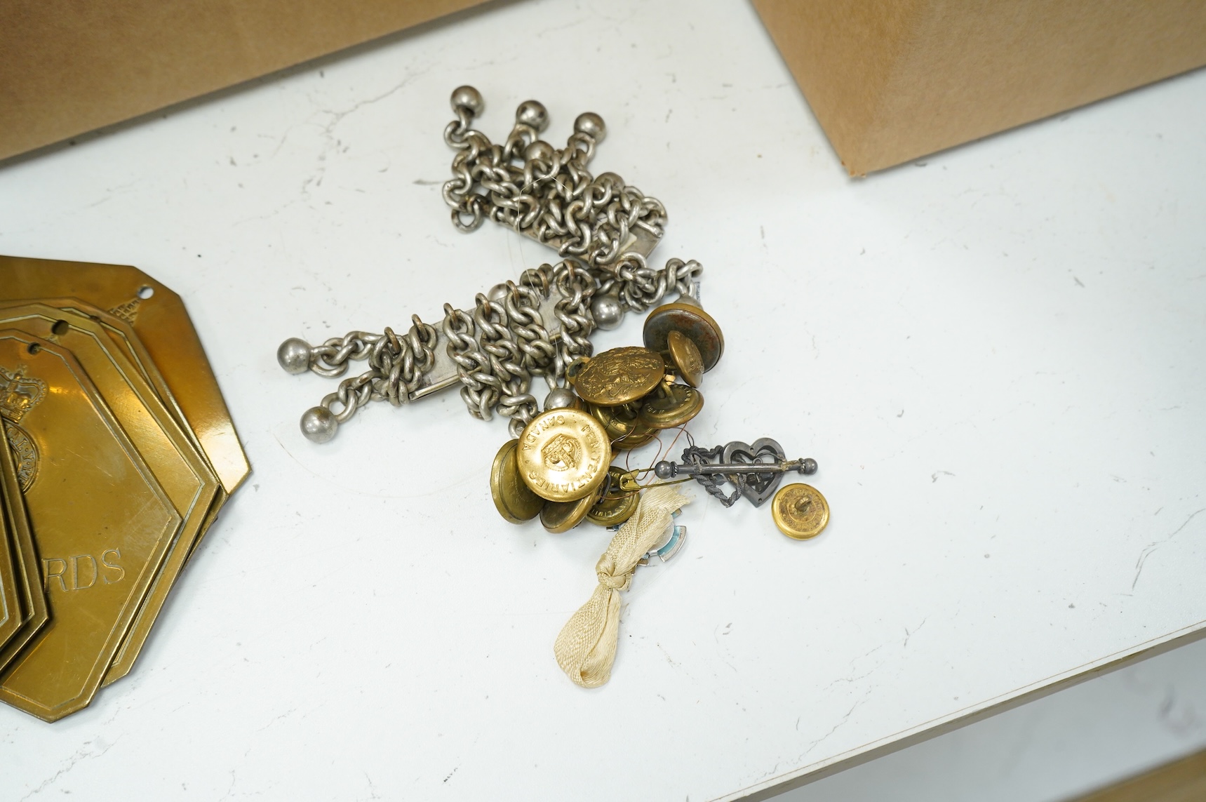 A collection of militaria, etc. including; a Gordon Highlander’s kilt and sporran, three early 20th century Union Flags, a Victorian beaded ‘sweetheart’s’ cushion, two empty First World War Princess Mary Christmas tins,